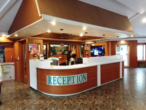 a restaurant with a reception desk in a building at Ellora Heritage Resort in Ellora