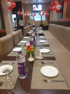 a long table with plates and bottles of water on it at Buddha Imperial in Muzaffarpur