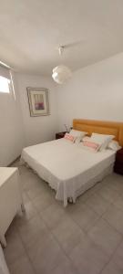 ein Schlafzimmer mit einem großen weißen Bett in einem Zimmer in der Unterkunft APARTAMENTO EN EL MEDANO - ESTRELLA DEL MAR in Granadilla de Abona