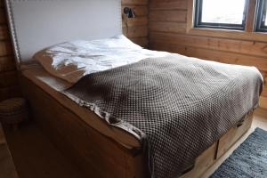 a bed in a small room with a window at Trysilsetra 35 in Trysil