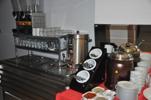a kitchen with a counter with a coffee maker and dishes at KOÇ OTEL ELİT TERMİNAL in Isparta
