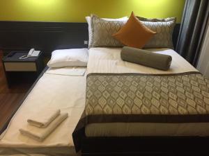a large bed with two towels and pillows on it at KOÇ OTEL ELİT TERMİNAL in Isparta