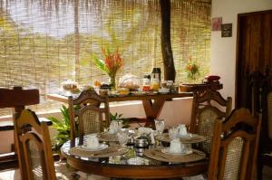 a dining room table and chairs with a table and a window at Nossa Senhora Aparecida in Marau