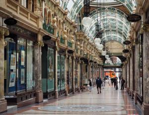 a shopping mall with people walking through it at Tong Apartments in Leeds