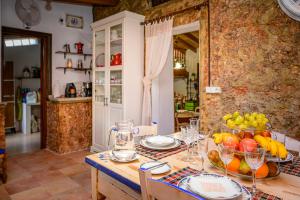 a table with a bowl of fruit in a kitchen at Nice Majorcan country house Sta Maria del Camí by Renthousing in Santa Maria del Camí