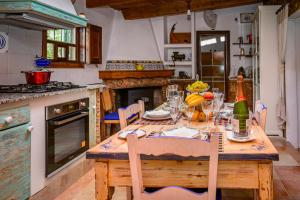 a kitchen with a wooden table with chairs and a tableablish at Nice Majorcan country house Sta Maria del Camí by Renthousing in Santa Maria del Camí