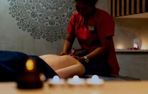 a woman giving a girl a massage in a room at Jess Hotel & Spa Warsaw Old Town in Warsaw