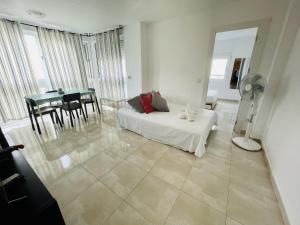 a living room with a white couch and a table at A697 - Club Médico - 2004 Finestrat s.l. in Benidorm