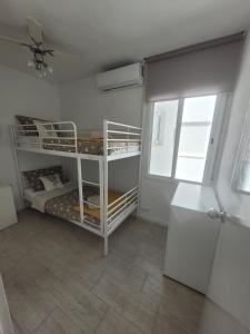 a room with two bunk beds and a window at Bella Apartment Playa Del Cura in Torrevieja