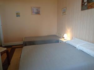 - une chambre avec deux lits et une lampe sur une table dans l'établissement appt T2 C Bougue, à Soustons