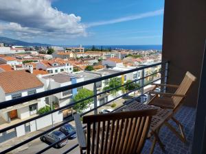 a balcony with a bench and a view of a city at Azores Essence - Paim in Ponta Delgada