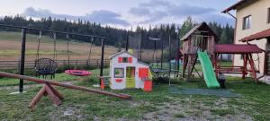 a playground with a play set and a slide at Pensiunea Catalina in Moldova Suliţa