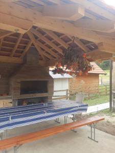 a picnic table under a pavilion with a wooden roof at Vikendica Jovicic in Kraljevo
