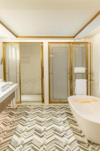 a bathroom with a large tub and a shower at Jumeirah Beach Hotel Dubai in Dubai