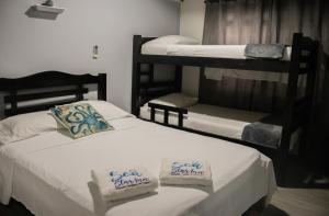 a bedroom with two bunk beds with towels on them at Sea Star Inn in San Andrés