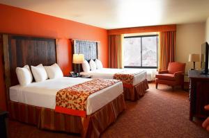 a hotel room with two beds and a chair at Hoover Dam Lodge in Boulder City