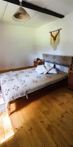 a large bed in a room with a wooden floor at Siedlisko Liskowate - Bieszczady in Ustrzyki Dolne