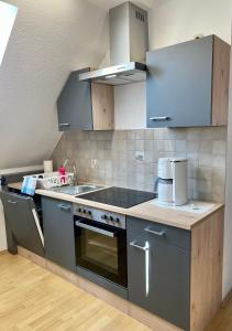 a kitchen with a sink and a stove top oven at FeWo Riedel in Weida