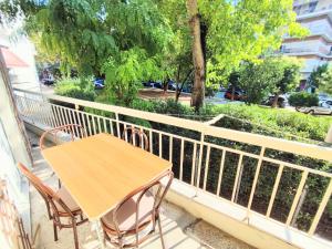 a wooden table and chairs sitting on a balcony at 3BR Spacious City Center in Thessaloniki