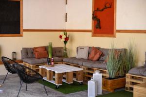 a living room with a couch and a table and chairs at Champagne Philippe Martin in CumiÃ¨res