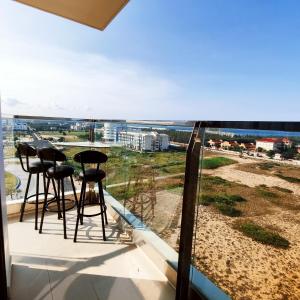 a balcony with stools and a view of the ocean at Beach apartment apec Phú Yên in Tuy Hoa