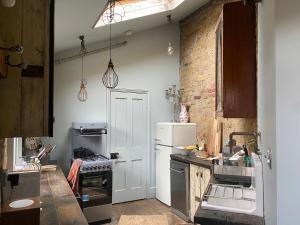 a kitchen with a white refrigerator and a sink at Campania & Jones House in London
