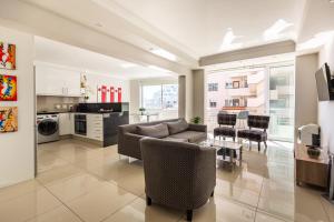 a living room with a couch and a table at Perfect Beachfront Apartments in Cape Town