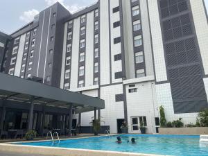 une piscine d'hôtel en face d'un bâtiment dans l'établissement Hotel Franco Yaounde, à Yaoundé
