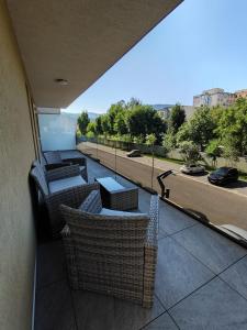 a balcony with chairs and tables on a building at Plaza Residence in Braşov