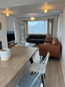 a living room with a wooden table and a couch at Pass the Keys The Sands Superb Newly Refurbished Beach Home in Rye