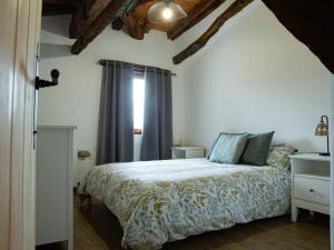 a bedroom with a bed and a window at Okana Baserria in Muxika