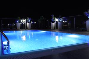 a large blue swimming pool at night with lights at Sky Roof Hotel in Lefkosa Turk