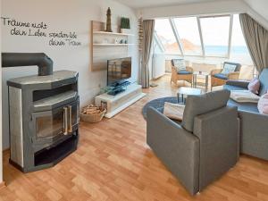 a living room with a fireplace and a couch at Apartmenthaus Jahreszeiten - Meerblick-Fewo 28 in Binz