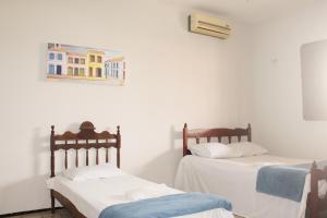 Uma cama ou camas num quarto em Hotel Pousada Calhau