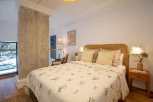 a bedroom with a large bed and a window at ApartUP Opera Loft Love in Valencia