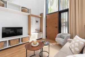 a living room with a couch and a table at ApartUP Opera Loft Love in Valencia