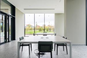 a conference room with a table and chairs and windows at ALTDIO UpTown Flats with Balcony, Good Connection to Milan Centre in Milan