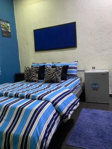 two beds sitting next to each other in a room at NUMBERS FLIPPERS SERVICES Apartment in Ikeja