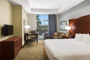 a hotel room with a bed and a desk at Staybridge Suites Las Vegas - Stadium District in Las Vegas