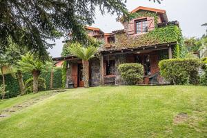 a house with a large yard in front of it at Villa Achada da Mouca by Madeira Sun Travel in Santana