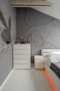 a bedroom with a bed and a stone wall at Grey House in Vilnius