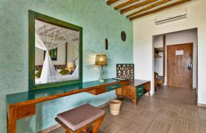 a room with a dressing table and a mirror at Zanzibar Queen Hotel in Matemwe