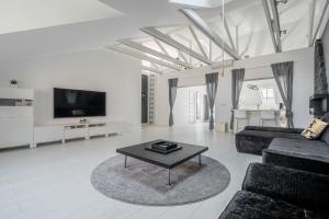 a living room with a couch and a coffee table at Grey House in Vilnius
