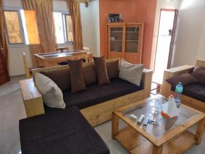 a living room with a couch and a table at CHAMBRES PRIVEES CLIMATISEES-DOUCHES PERSONNELLES-NEFLIX-SALON in Dakar
