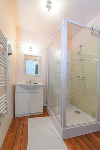 ein Bad mit einer Dusche und einem Waschbecken in der Unterkunft HOTEL DES VOYAGEURS in Pont-de-Roide