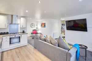 a living room with a couch and a kitchen at Host & Stay - Park Base in Tynemouth