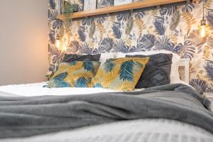 a bed with two pillows on top of it at Vibrant City Centre Living in Aberdeen +37 photos