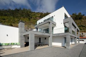 a white house on top of a hill at SKYFALL VILLA in Arco da Calheta