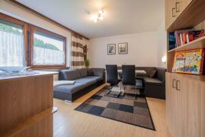a living room with a couch and a table at Gästeheim Krößbach in Neustift im Stubaital