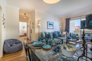 a living room with a table and a couch at Atlantic Ocean View Apartment in Funchal